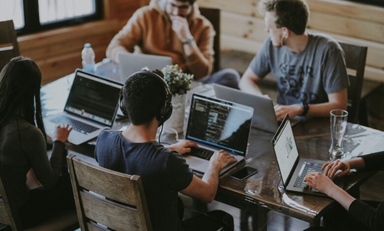 group of people using laptop computer